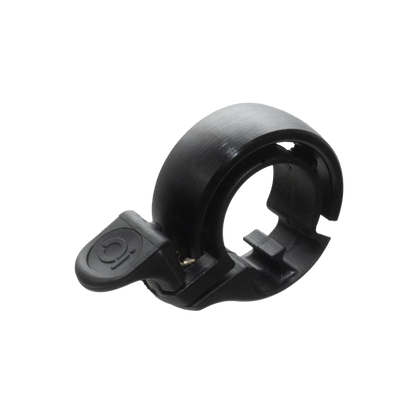 Schwarze Knog Oi Classic Fahrradklingel mit ringförmigem Design, strukturierter Oberfläche und Hebel mit Logo